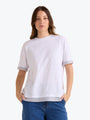 Woman wearing a white t-shirt with gray trim on a white background