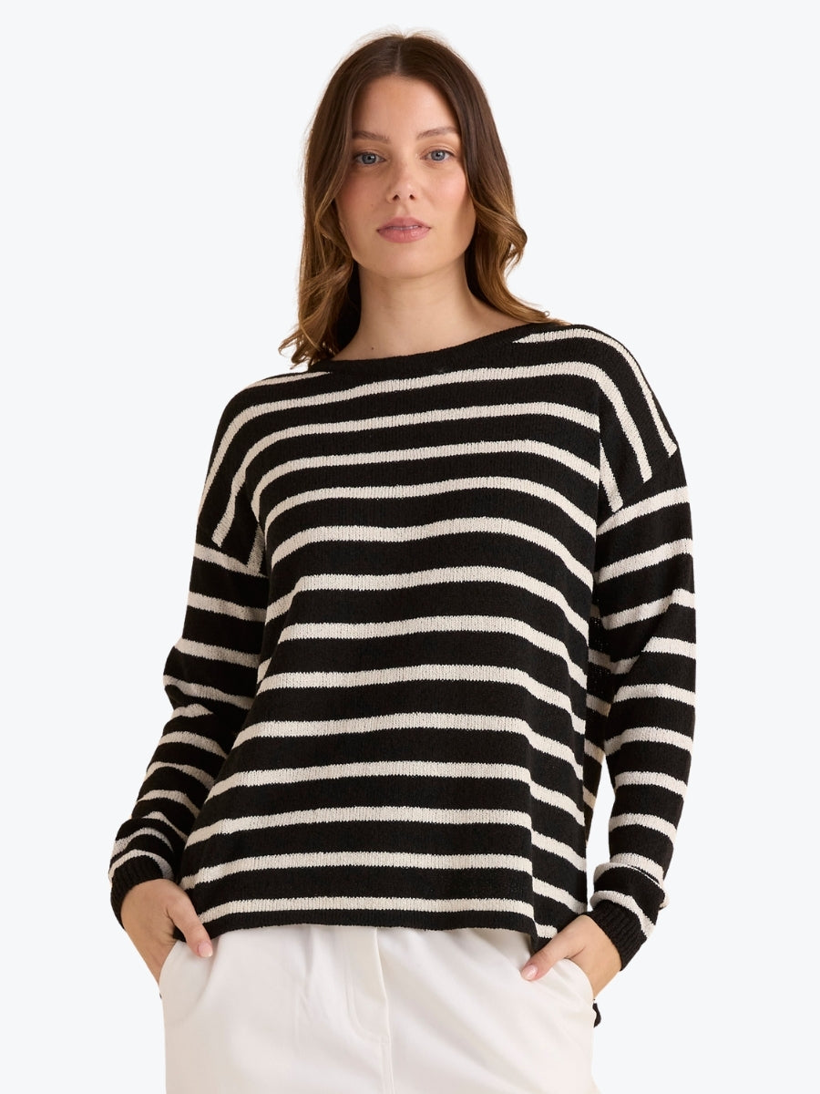 Woman wearing a black and white striped sweater on a white background