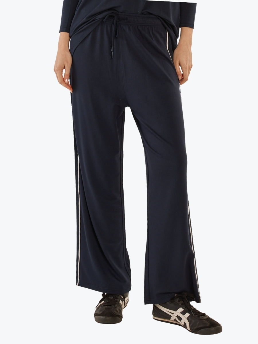 Navy blue wide-leg pants with a white stripe on a white background
