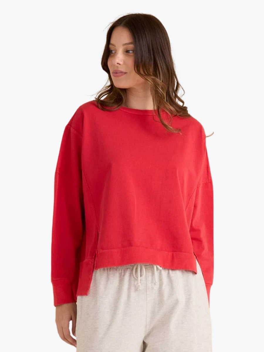 Woman wearing a red sweatshirt on a white background