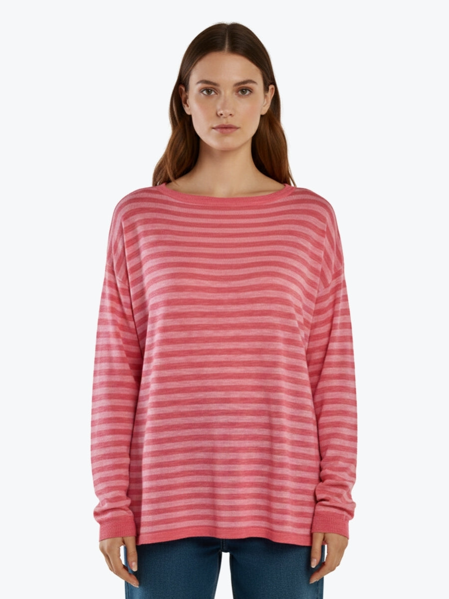 Woman wearing a pink striped sweater on a white background