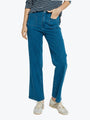 Person wearing blue jeans and a striped shirt on a white background