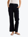 Person wearing black pants on a white background