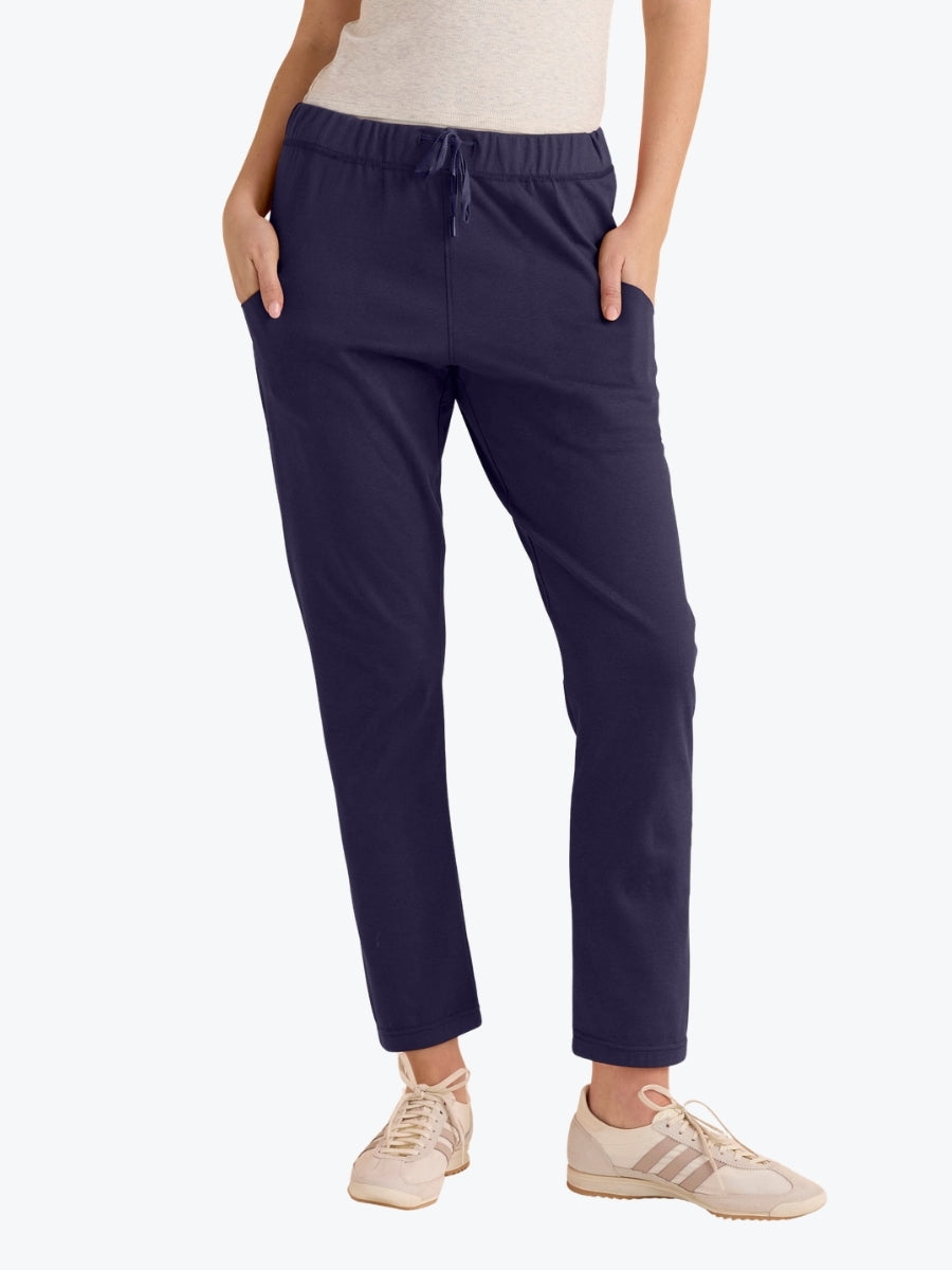 Navy blue pants worn by a person on a white background