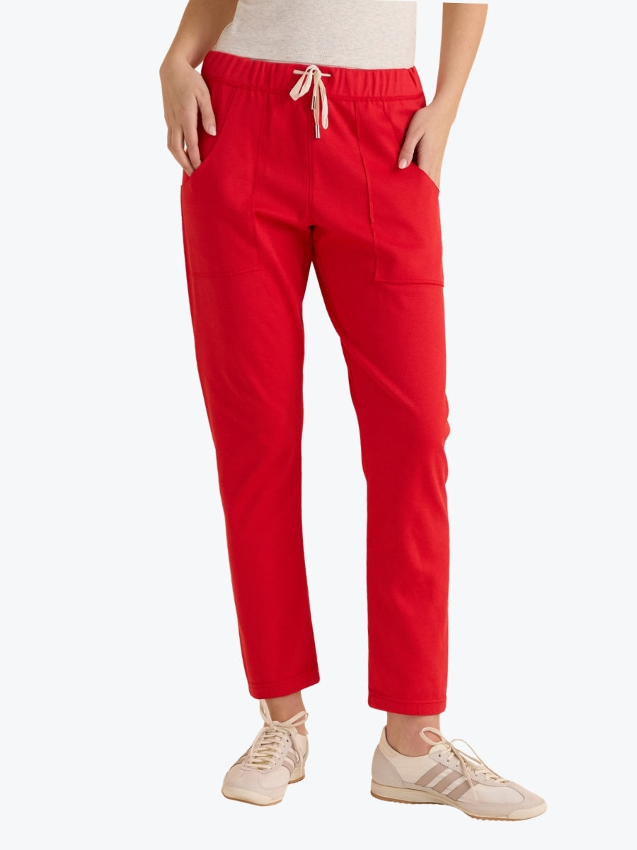 Red pants worn by a person on a white background