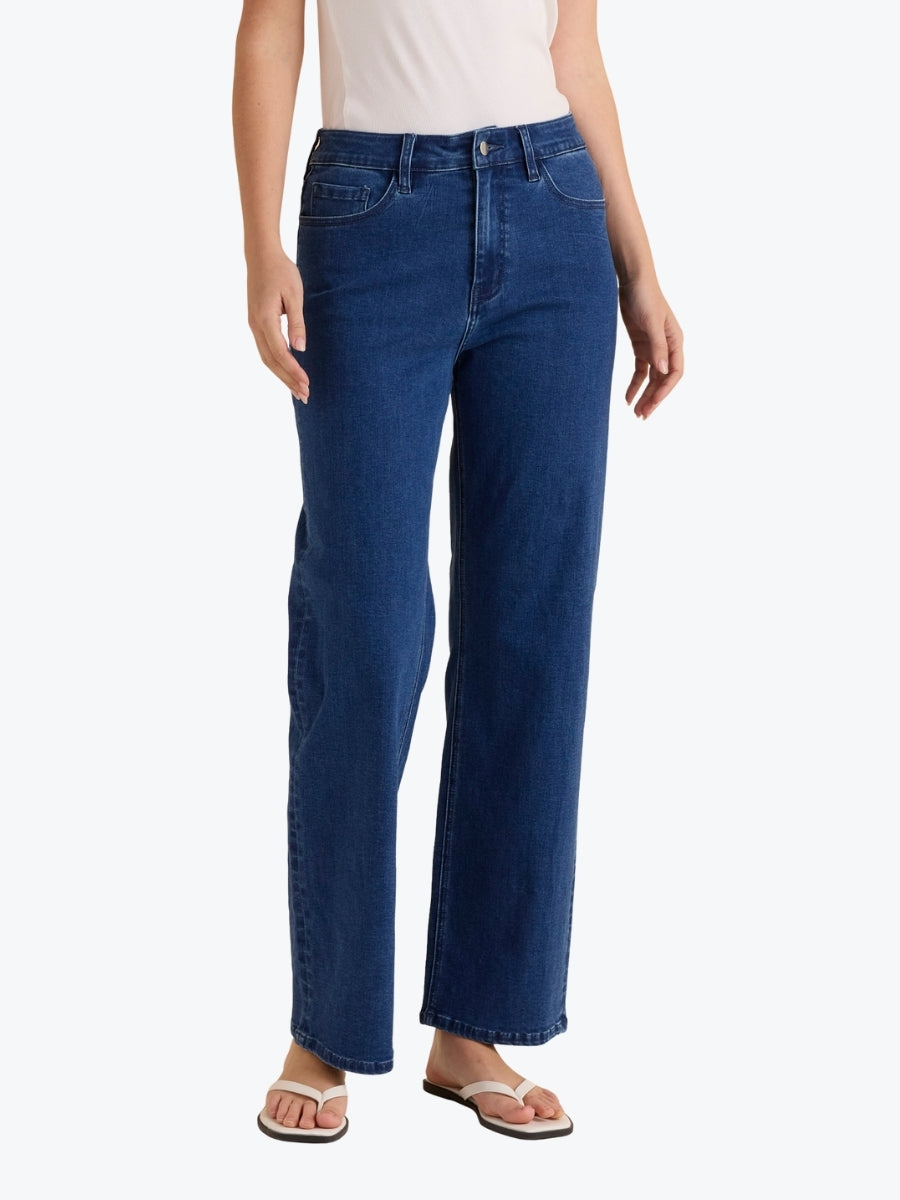 Person wearing blue jeans on a white background