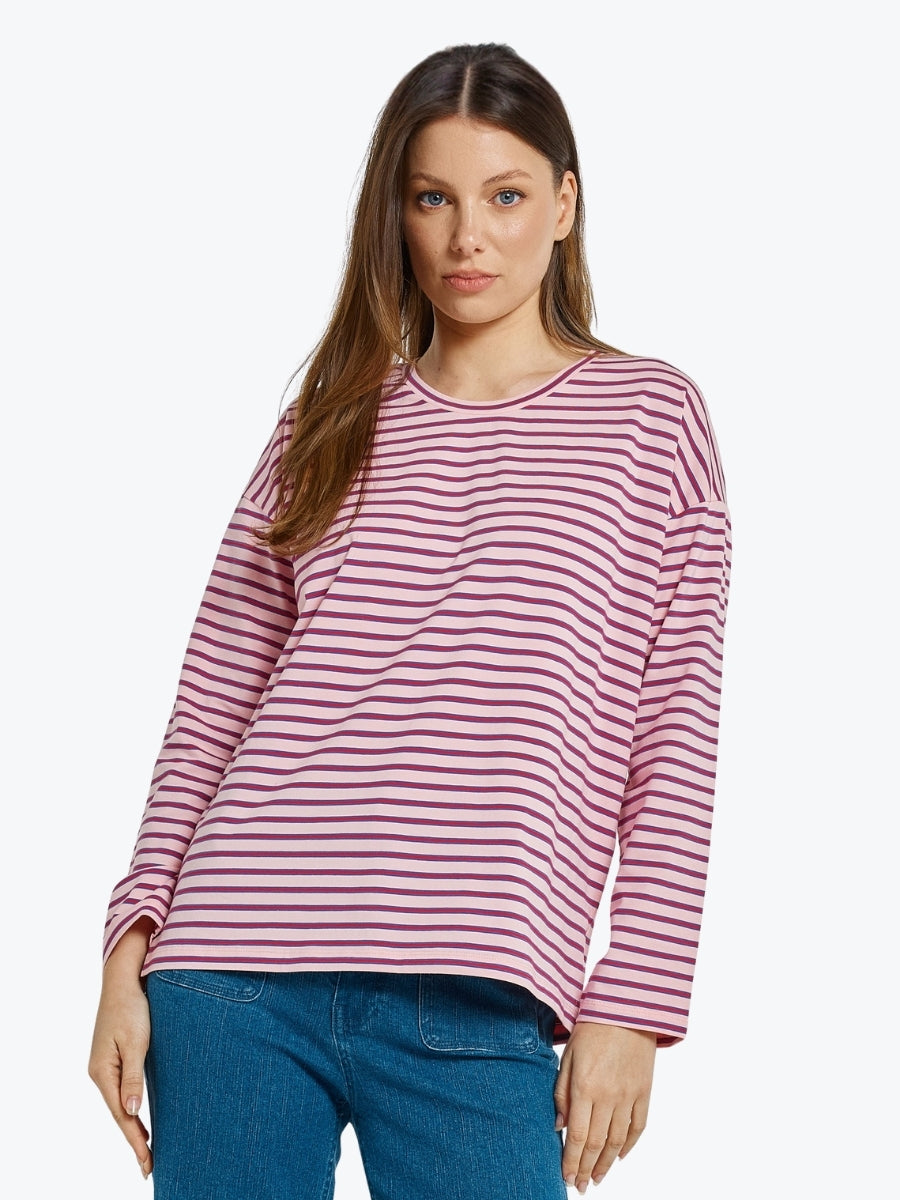 Woman wearing a pink and white striped long-sleeve shirt on a white background