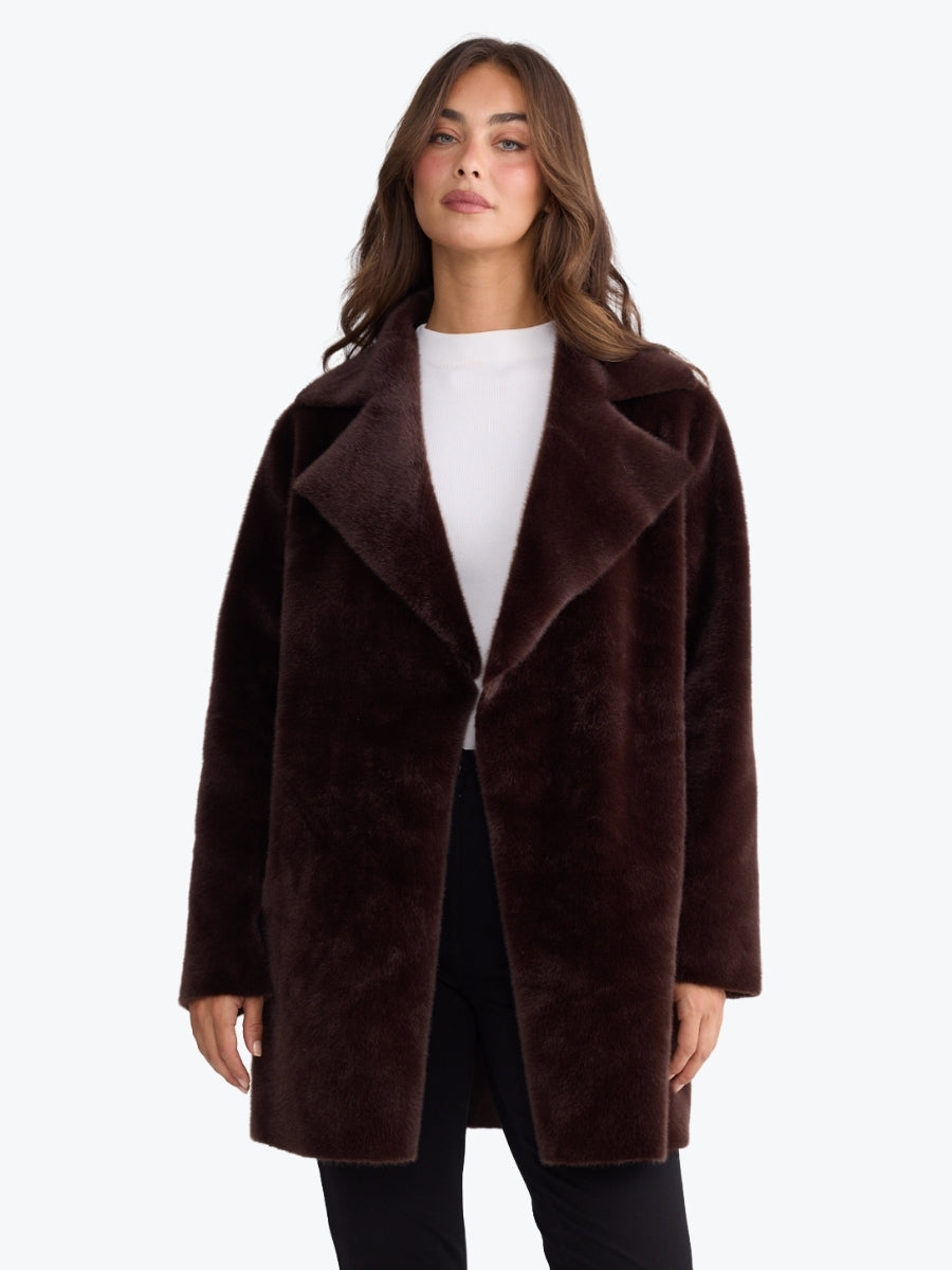 Woman wearing a brown coat on a white background