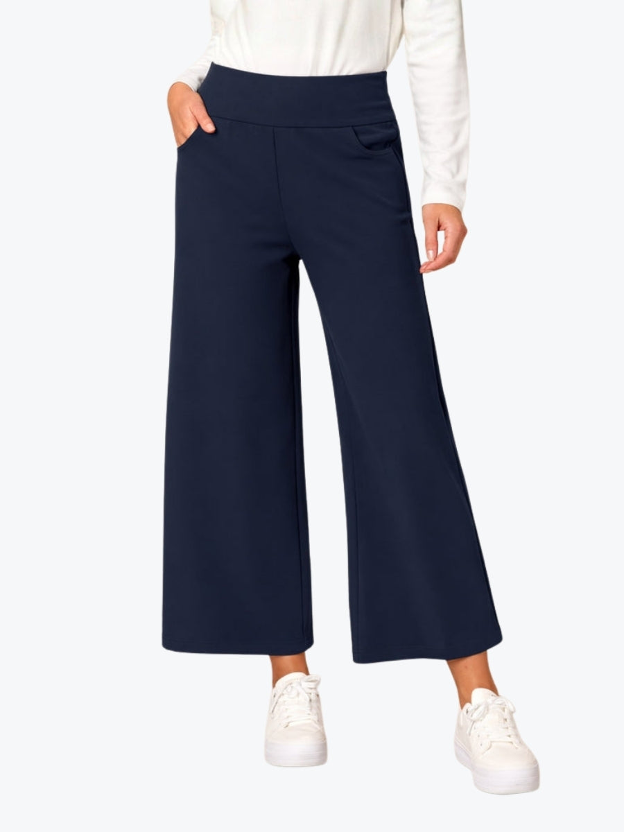 Navy wide-leg pants worn by a person on a white background