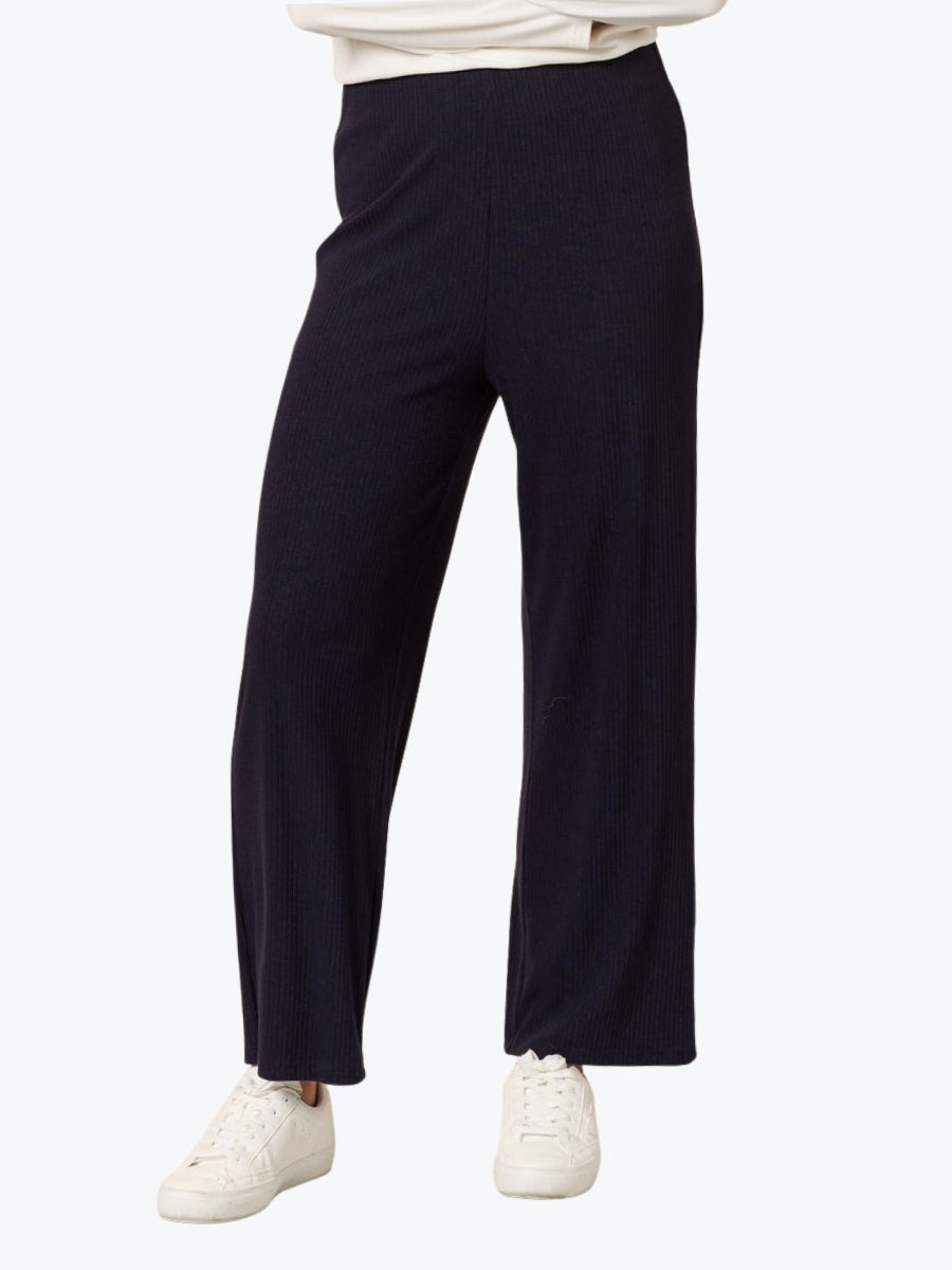 Navy wide-leg pants worn by a person on a white background