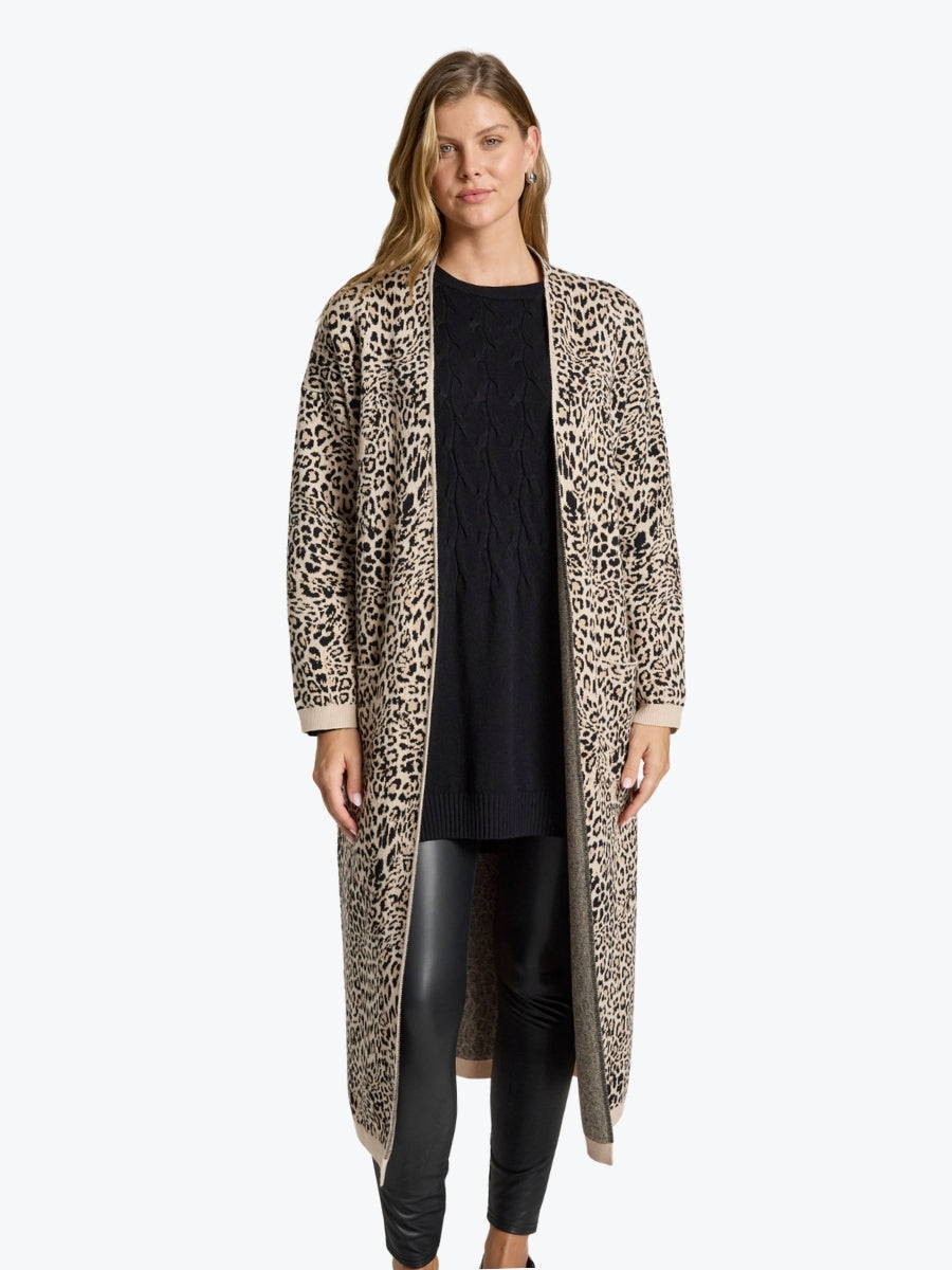 Woman wearing a leopard print cardigan on a white background