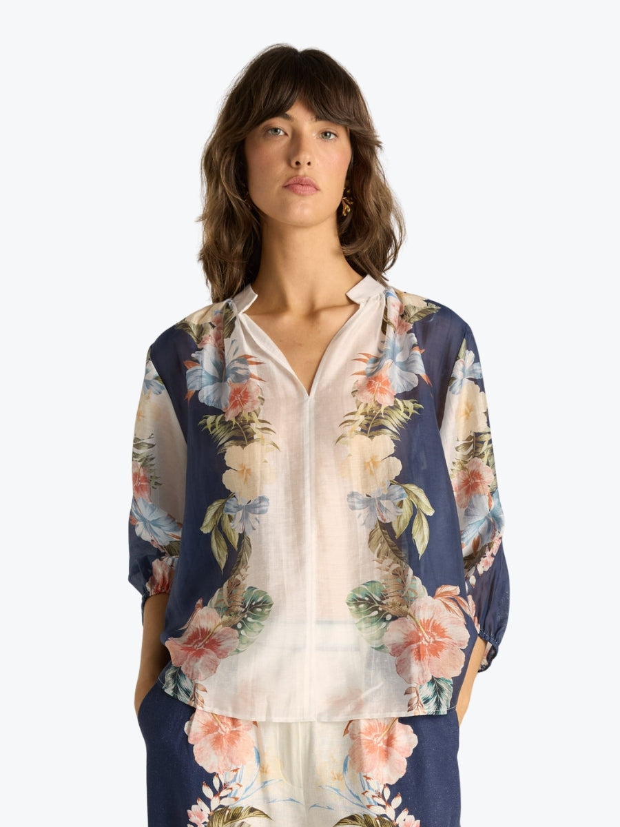 Woman wearing a floral blouse on a white background