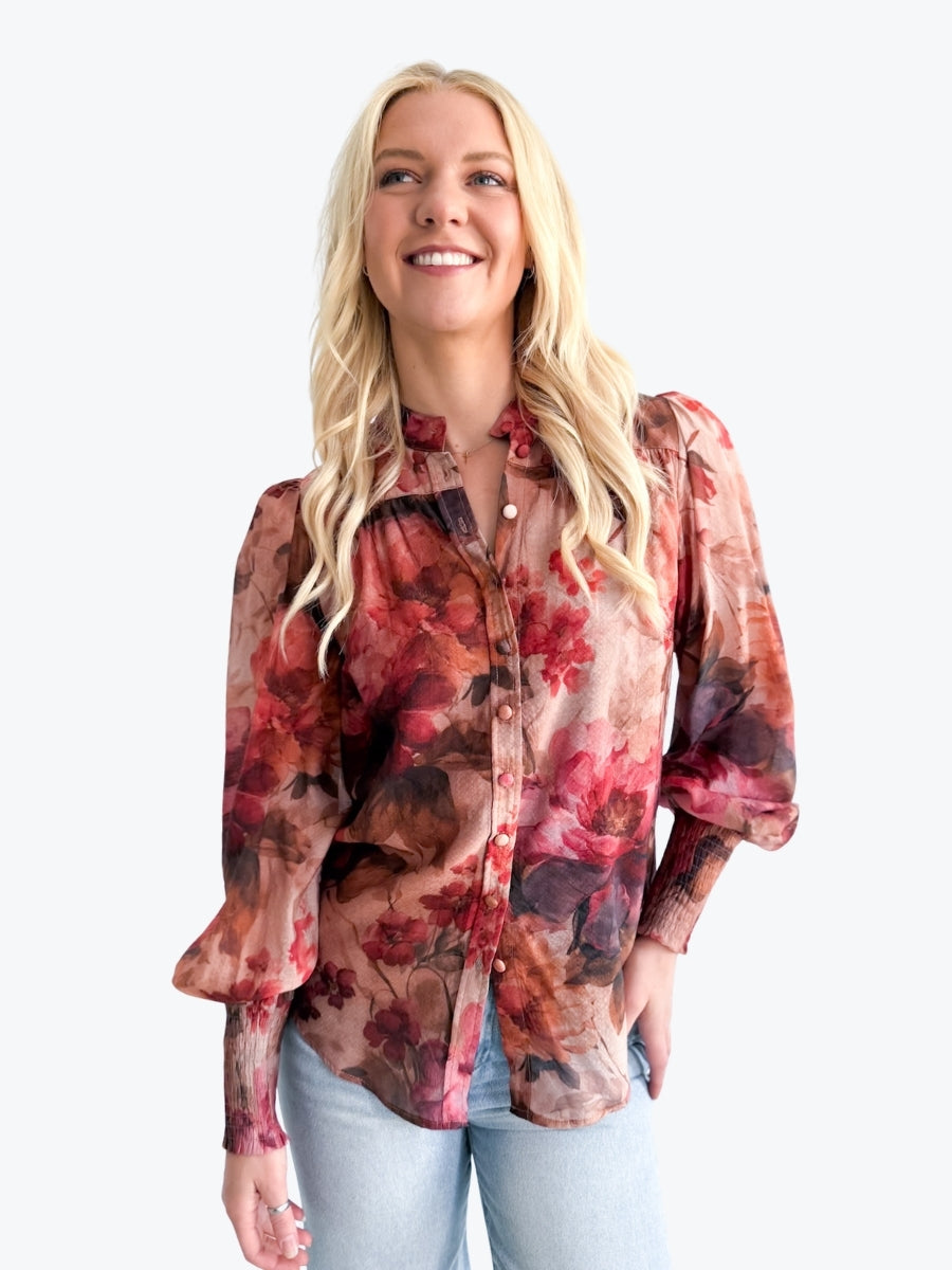 Woman wearing a floral blouse with a white background