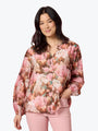 Woman wearing a floral blouse with a plain background