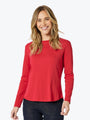 Woman wearing a red long-sleeve top on a white background