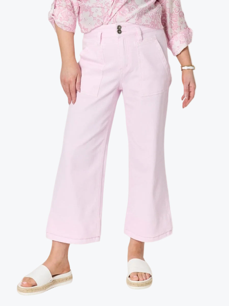 A model wearing light pink cropped wide-leg pants, a pink floral long-sleeve top, and white slide sandals, shown from the waist down on a white background.