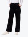 Person wearing black pants and a white shirt on a white background