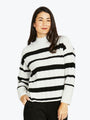 Woman wearing a black and white striped sweater on a white background