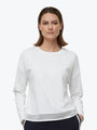 Woman wearing a white long-sleeve shirt on a white background