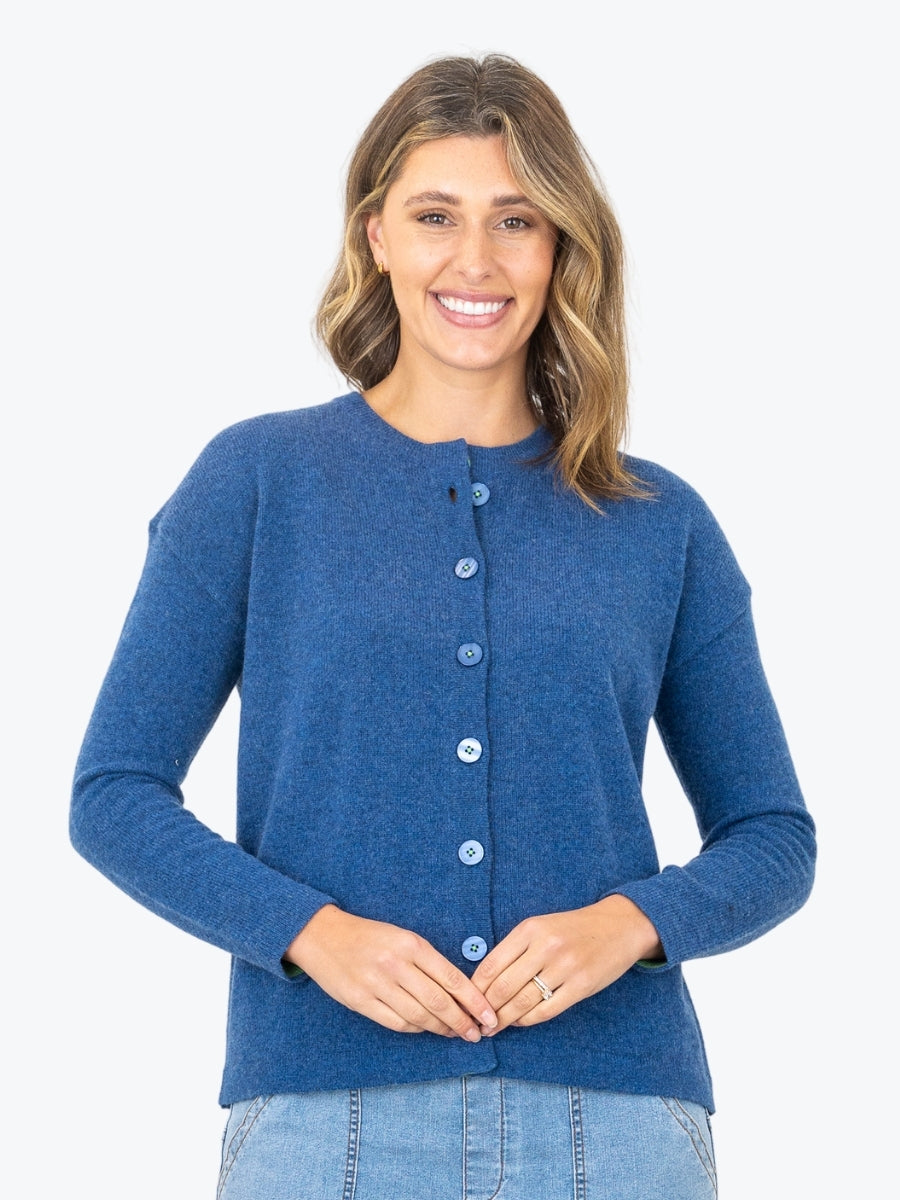 Woman wearing a blue cardigan on a white background