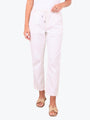 A model wearing light pink cropped pants with a drawstring waistband, paired with beige slide sandals, against a plain white background.
