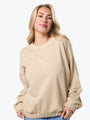 Woman wearing a beige sweater on a white background