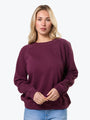 Woman wearing a purple sweater on a white background