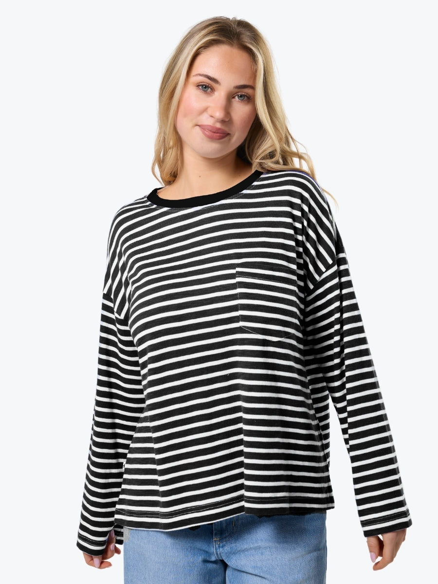 Woman wearing a black and white striped long-sleeve shirt on a white background