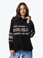 Woman wearing a black hoodie with leopard print sleeves on a white background