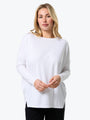 Woman wearing a white sweater on a white background