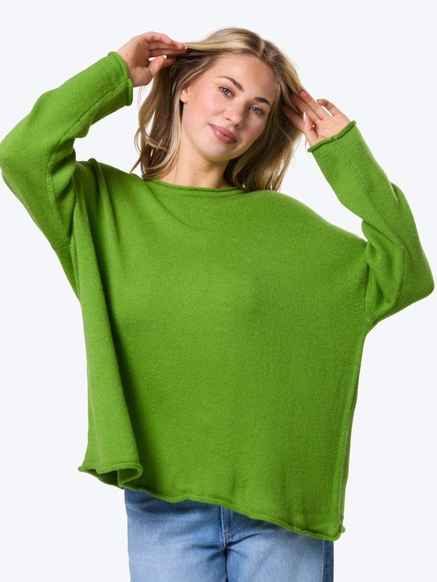 Woman wearing a green sweater on a white background