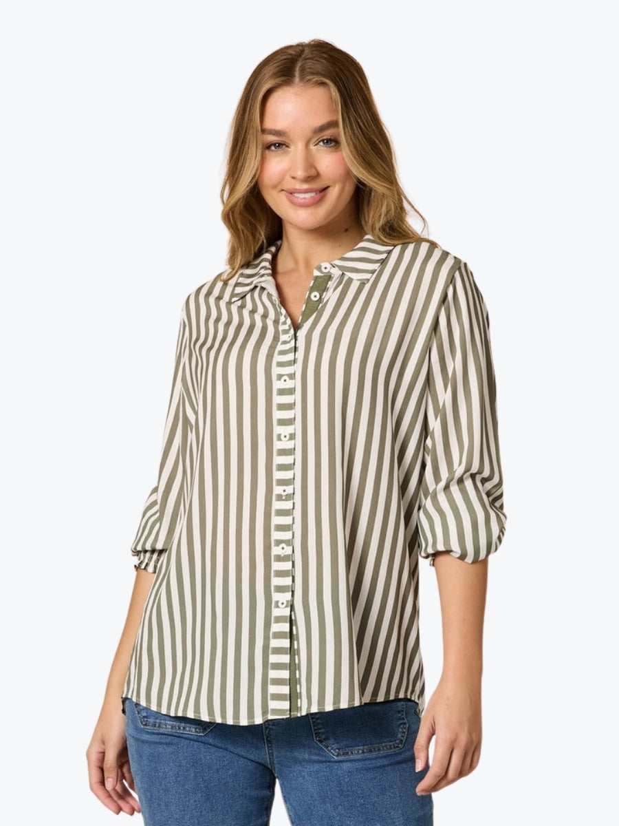 Woman wearing a striped shirt and jeans on a white background