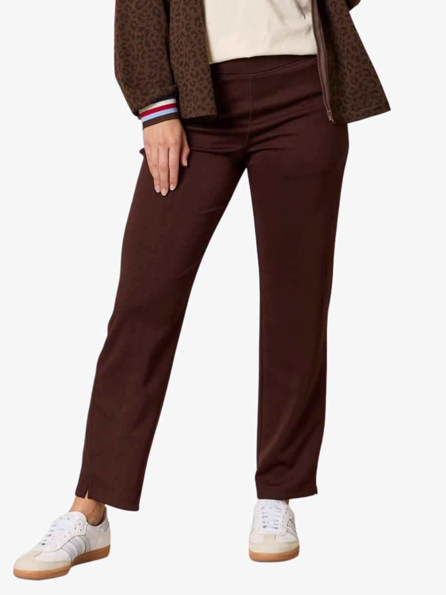 Brown pants worn by a person on a white background