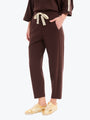 Brown outfit with a belt and gold shoes on a white background