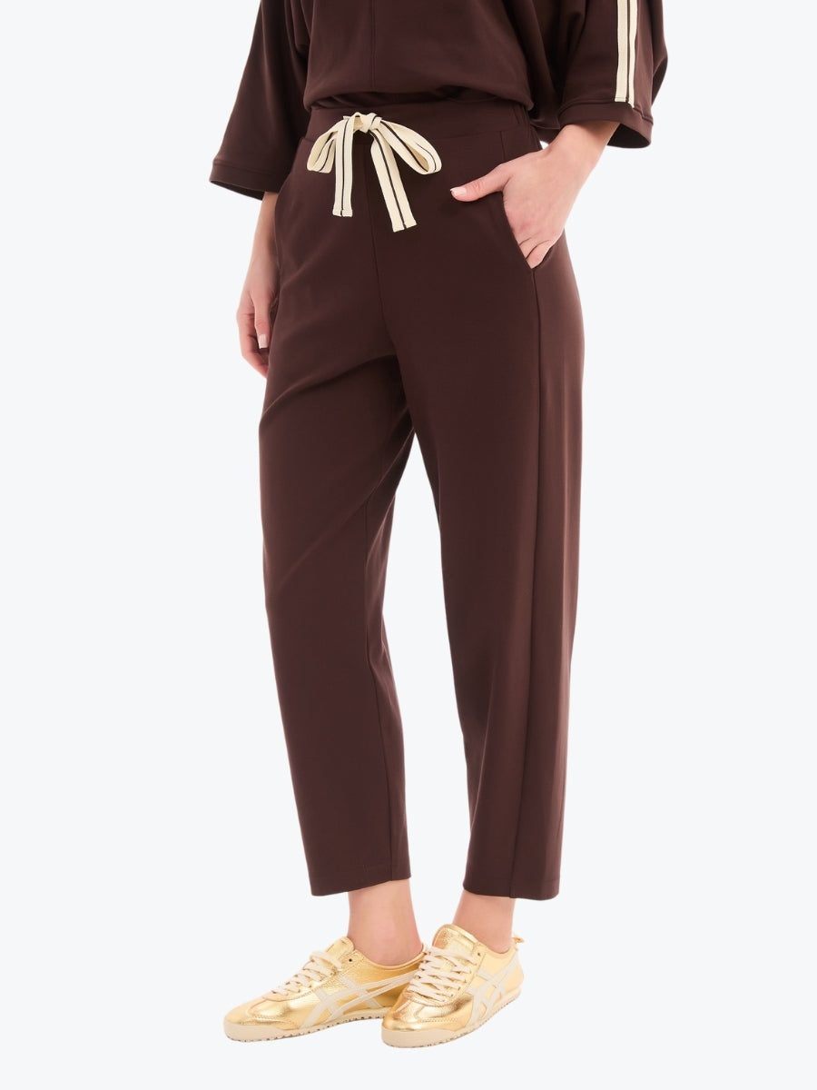 Brown outfit with a belt and gold shoes on a white background