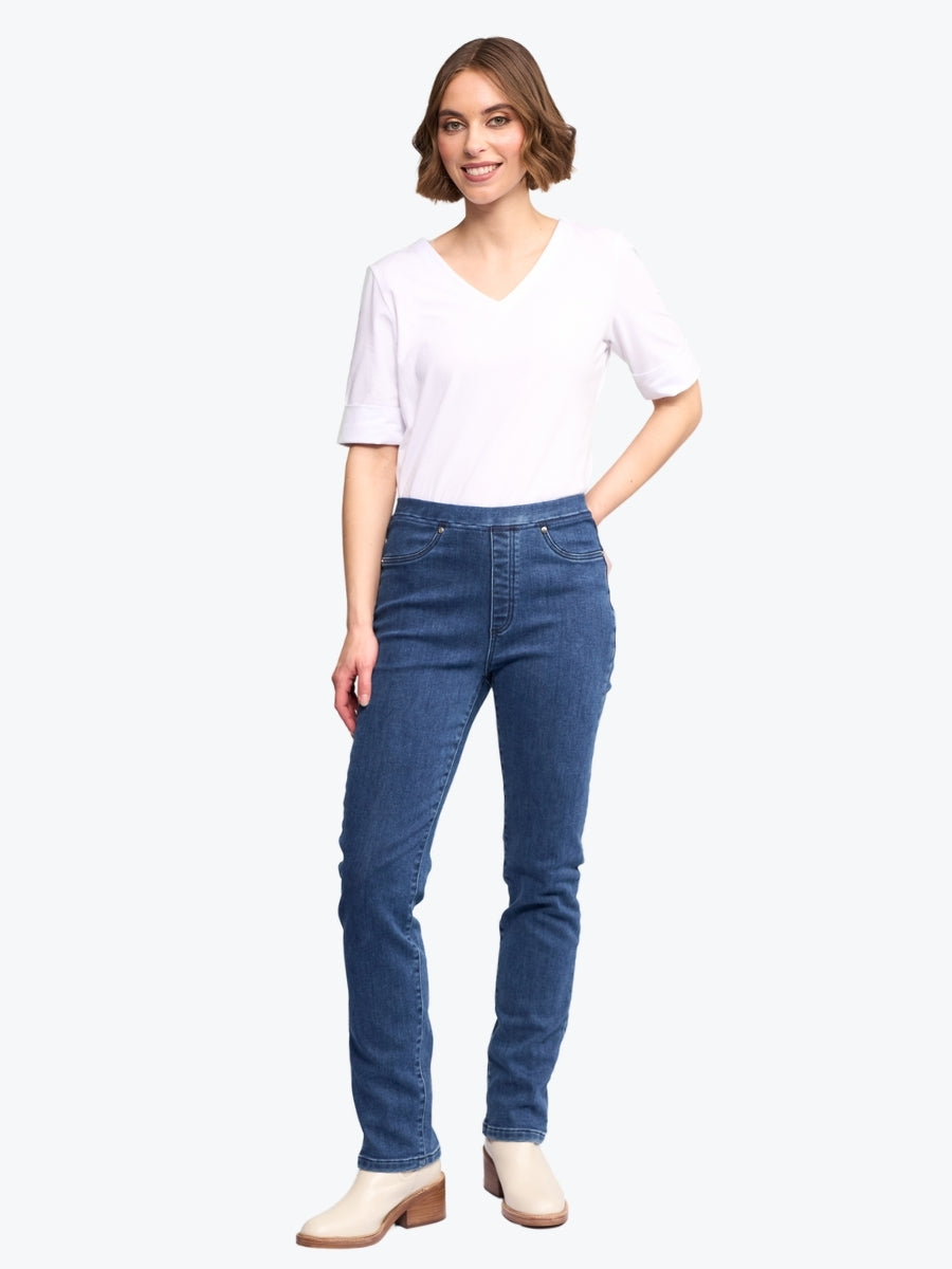 Woman wearing blue jeans and a white top on a white background