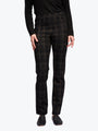 Person wearing black plaid pants on a white background