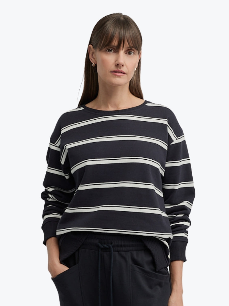 Woman wearing a black and white striped sweater on a white background