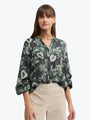 Woman wearing a floral blouse with a white background