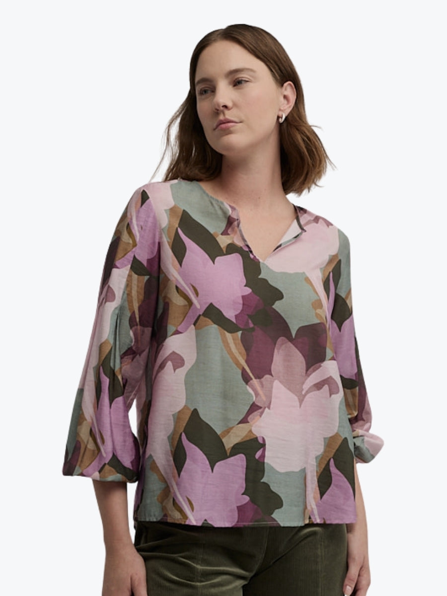Woman wearing a floral blouse with a white background