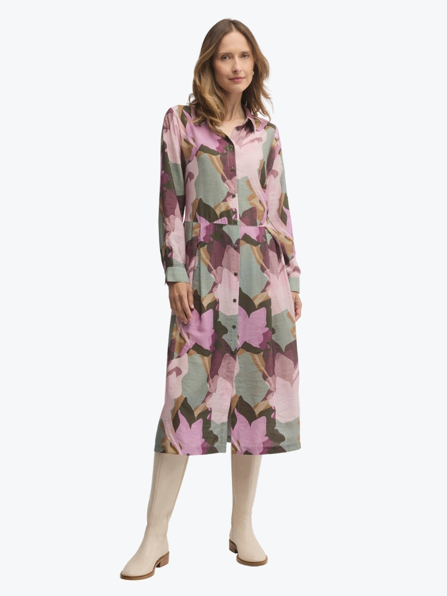 Woman wearing a patterned dress on a white background